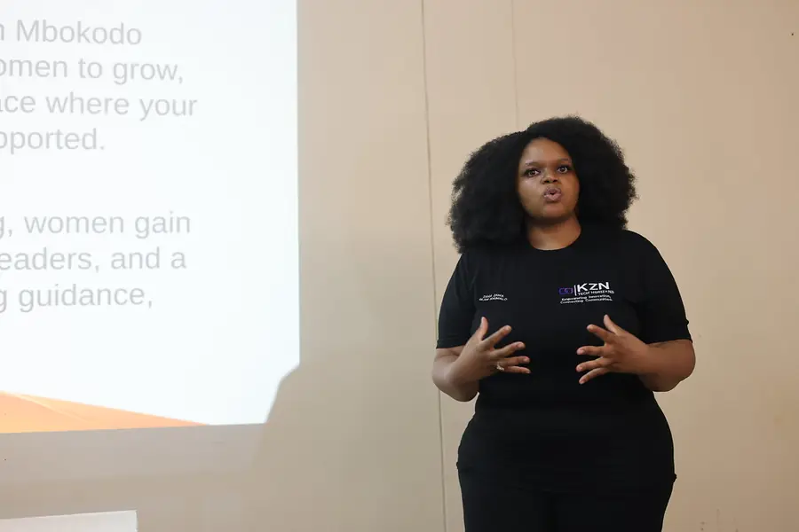 A Tech Horizons member speaking to a room at a community event.